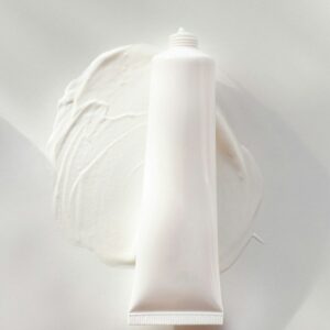 a tube of cream sitting on top of a white plate
