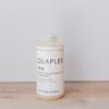 a bottle of olaplex on a wooden table